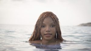 Image of Halle Bailey as Ariel with just her head sticking out of the water.
